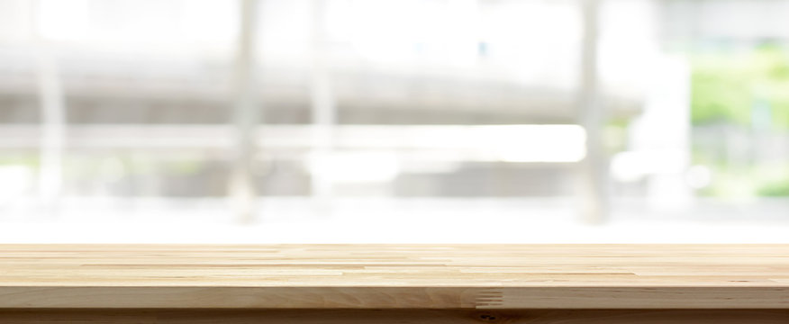 Wood table top on blur kitchen window background, panoramic banner