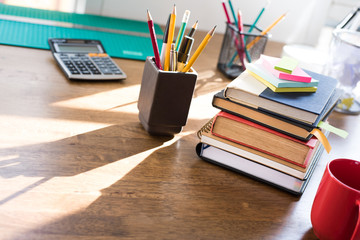 Stack of books and stationery on the  table