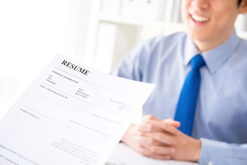 Young businessman submitting resume to employer to review