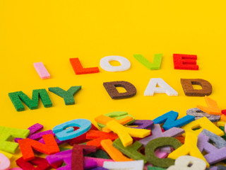 Father's day concept. I LOVE MY DAD alphabet on yellow background.