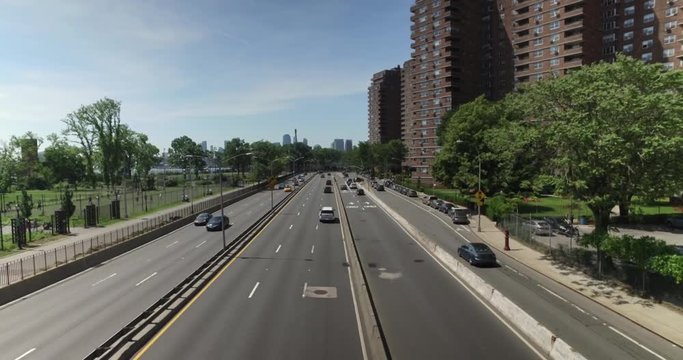 A high angle daytime establishing shot of traffic passing on FDR Drive on Manhattan's east side.  	