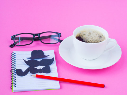 Father's day concept. compass, black glasses, coffee cup, gift and black Mustache on pink background
