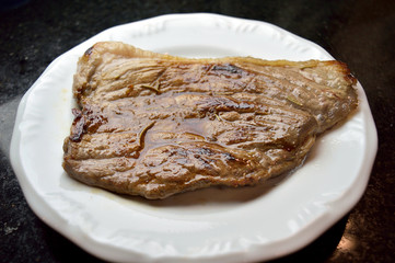 Nice piece of red meat beef on a plate ready to eat