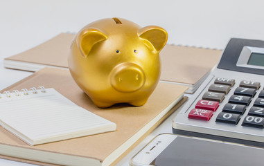 Pig piggy bank, calculator, phone, notebook, pen, concept of saving money.