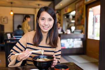Woman having japanese udon