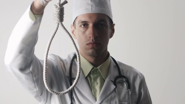 The doctor offers a choice between a noose and a medicine. The choice between suicide or treatment.