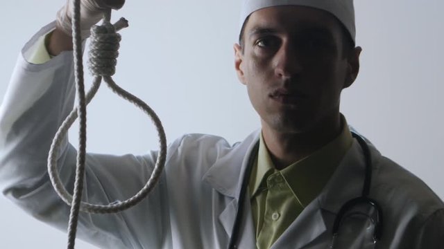 The doctor offers a choice between a noose and a medicine. The choice between suicide or treatment.