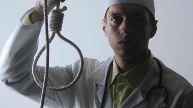 The doctor offers a choice between a noose and a medicine. The choice between suicide or treatment.