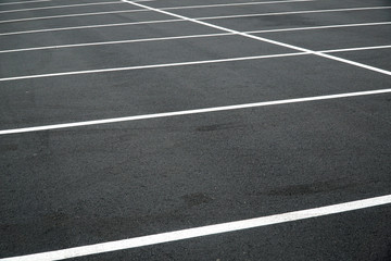 new paved empty parking lot with new painted strip lines