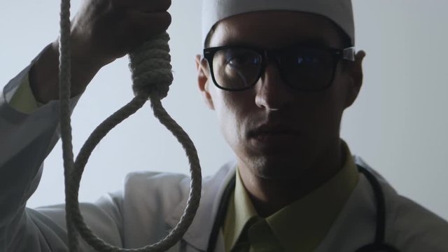 The doctor shows a noose. The medical worker advises suicide. The impotence of medicine.