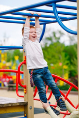 Fototapeta premium Little boy playing on the playground.