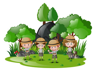 Obraz na płótnie Canvas Four kids in safari outfit having fun in the forest