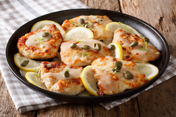 Italian cuisine: chicken piccata with sauce close-up. Horizontal