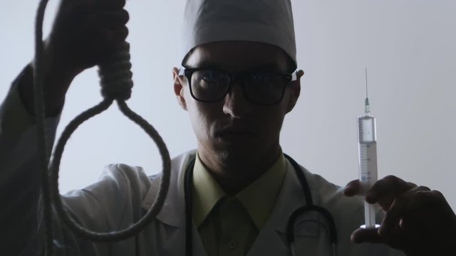 The doctor offers a choice between a noose and an injection. The choice between suicide or treatment.