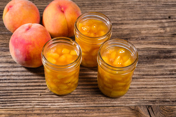 Yellow peaches and jars of pie filling