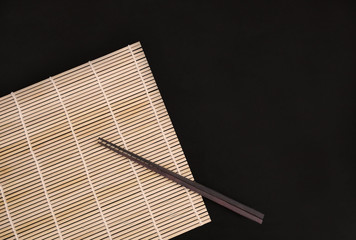 Chopsticks on bamboo mat