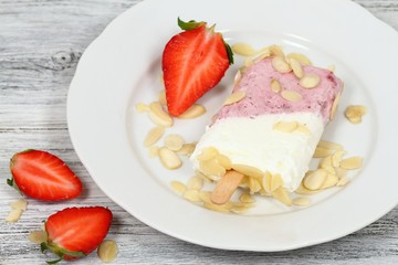 Ice lolly from strawberries, cottage cheese & almond pieces