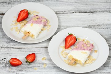 Ice lolly from strawberries, cottage cheese & almond pieces