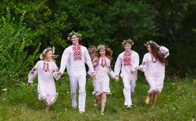 Fototapeta premium Midsummer. People running in nature in Slavic clothes.