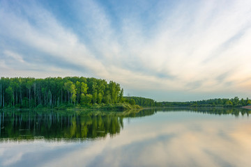 The mirrored surface of the river with reflection of clouds.