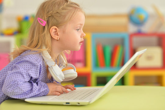 little girl using modern laptop