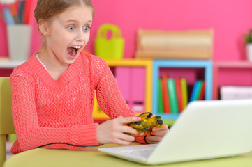 girl playing game on laptop