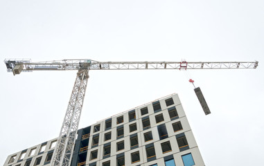 Fototapeta premium Industrial construction crane in the city.