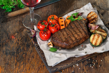 Beef grilled steak with grilled vegetables and red wine