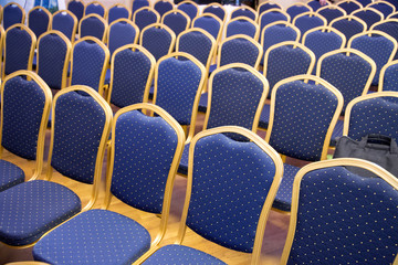 Naklejka premium Rows of blue empty seats in unknown event hall