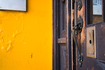 Bronze door handle on an old shabby front door