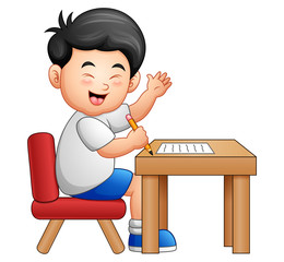 Cartoon boy learning at table giving thumbs up