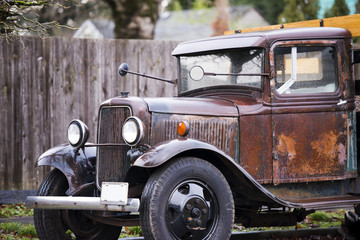 Old vintage rusty truck with the body gets wet from rain