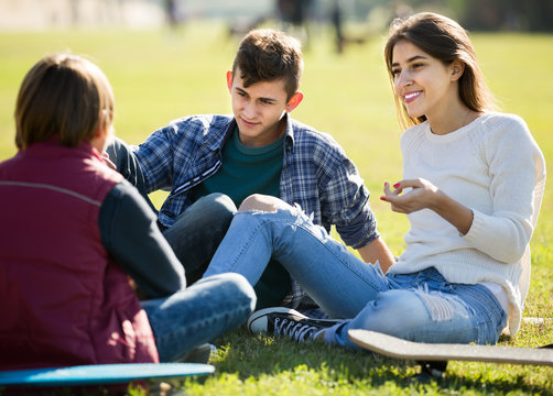 teenagers hanging out outdoors and discussing something
