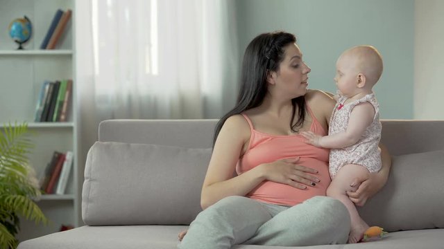Young lady expecting child, enjoying time with little baby, happy motherhood