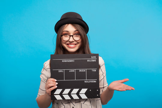 Woman posing with clapboard