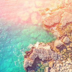 Fototapeta premium Rocky seashore, top view in the sunlight