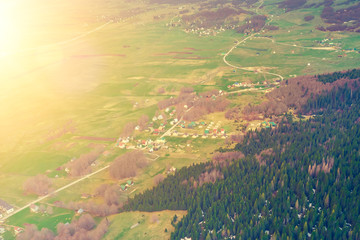 Top view of a village near the forest  in the sunlight