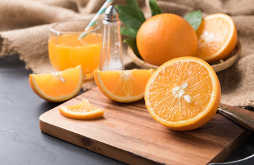 Fresh sliced orange on wood plate