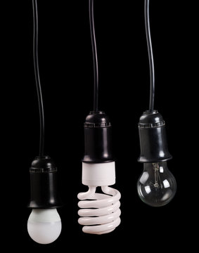 set of three electric lamps in receptacle on black
