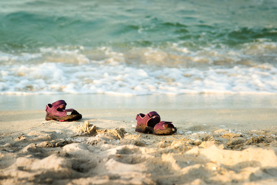 Pair of small sandals lost at the beach