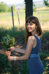 Surprise for girl gift flowers young surprised girl in the park.