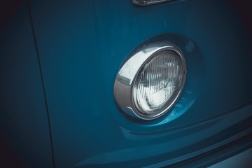 Headlights and body of an old classic car at an exhibition of vintage cars