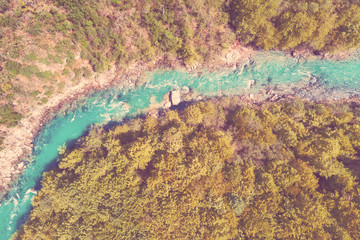 Top view of the river in the mountains surrounded by a forest