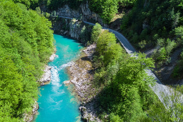 Top view of the river in the mountains surrounded by a green forest