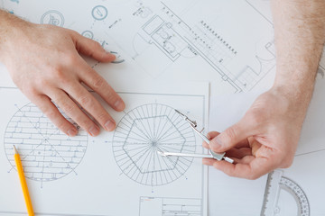 Flat lay photo of male hands while drawing sketch