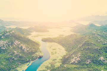 Top view of a river covered with green algae in the mountains on a sunny day