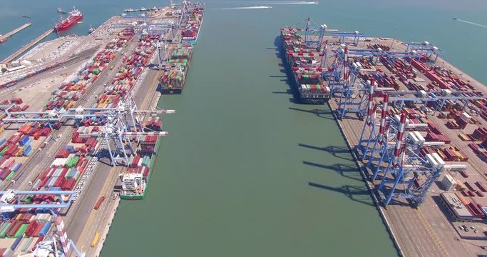 Aerial Time lapse - Commercial port with container ship during loading and unloading