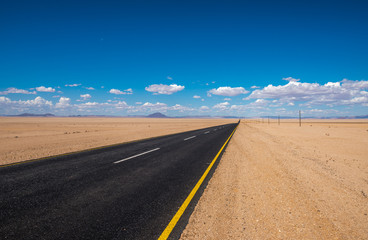 vibrant image of highway and blue cloudy sky