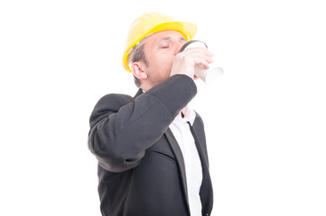 Contractor drinking takeaway coffee wearing hardhat