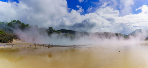 Panoramic image of the famous Champagne Pool covering of steam , Wai-O-Tapu geothermal area , Rotorua, North Island of New Zealand